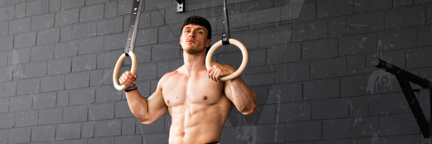 GORNATION athlete standing between the workout rings from GORNATION