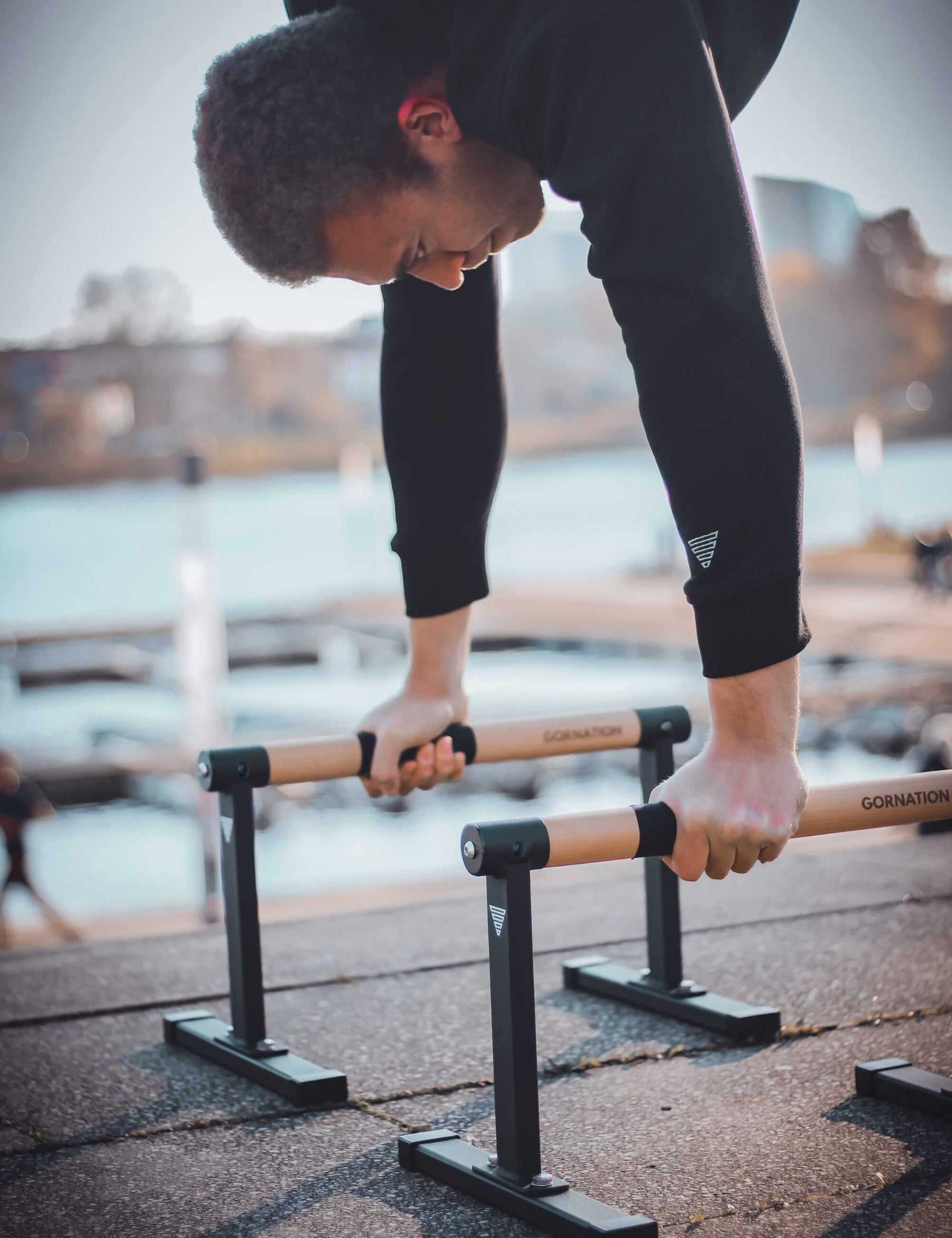 Calisthenics athlete performing handstand on the max paralettes from Gornation.