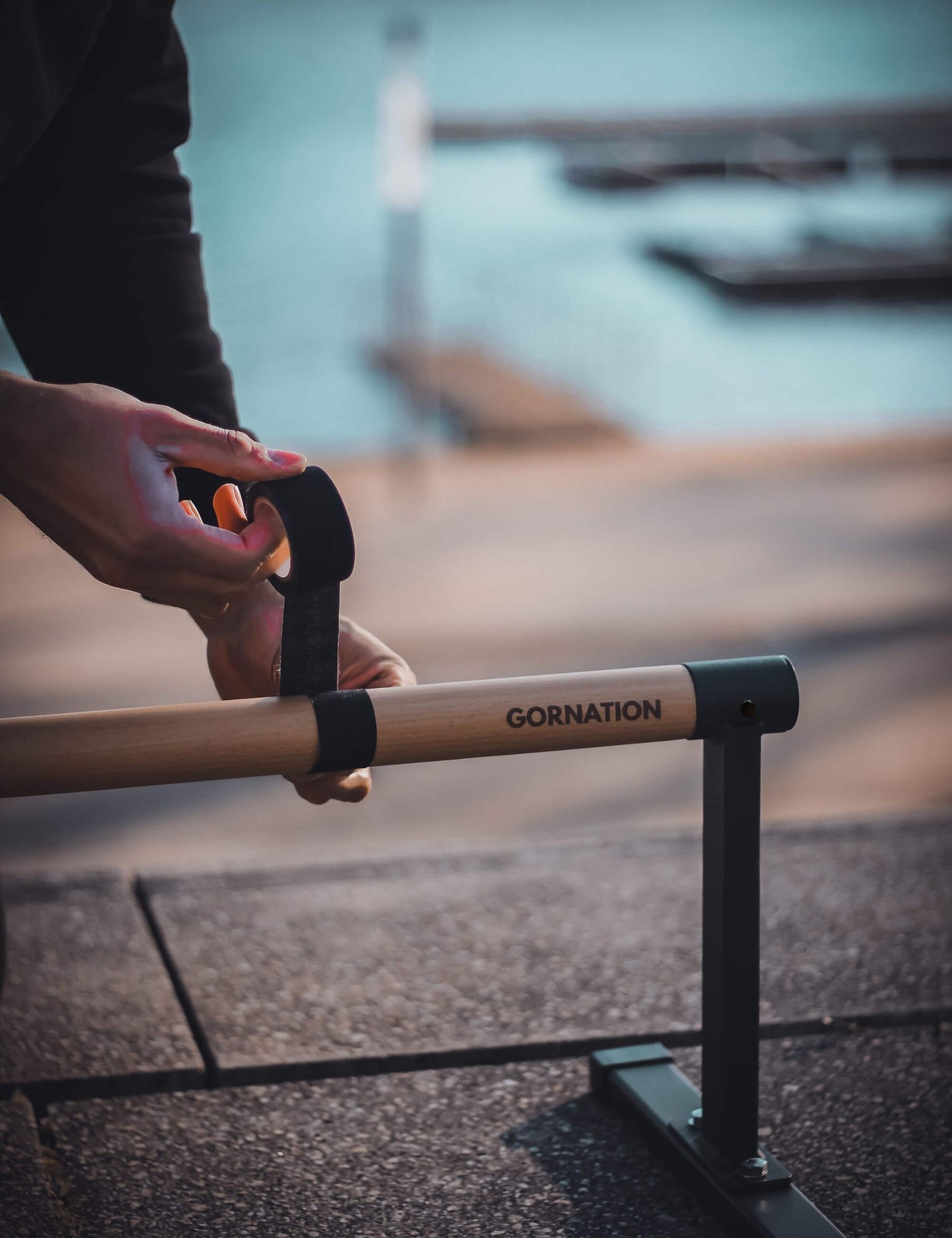 Athlete putting on the grip tape on the MAX paralettes.