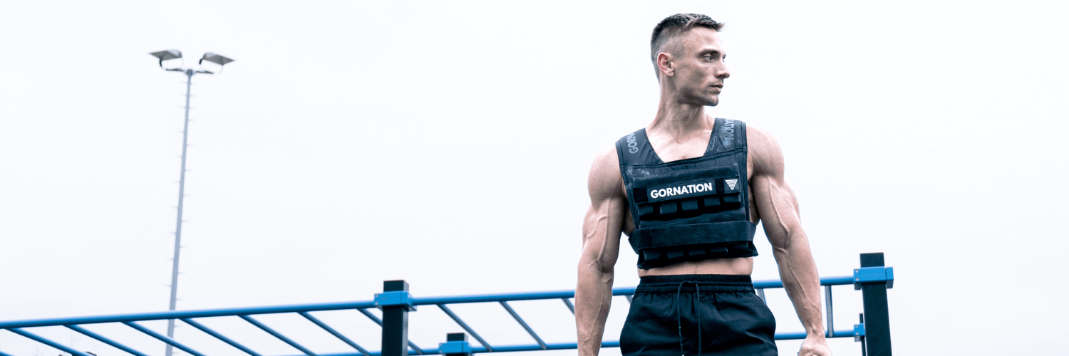 GORNATION athlete standing in a park with the GORNATION Weight Vest 