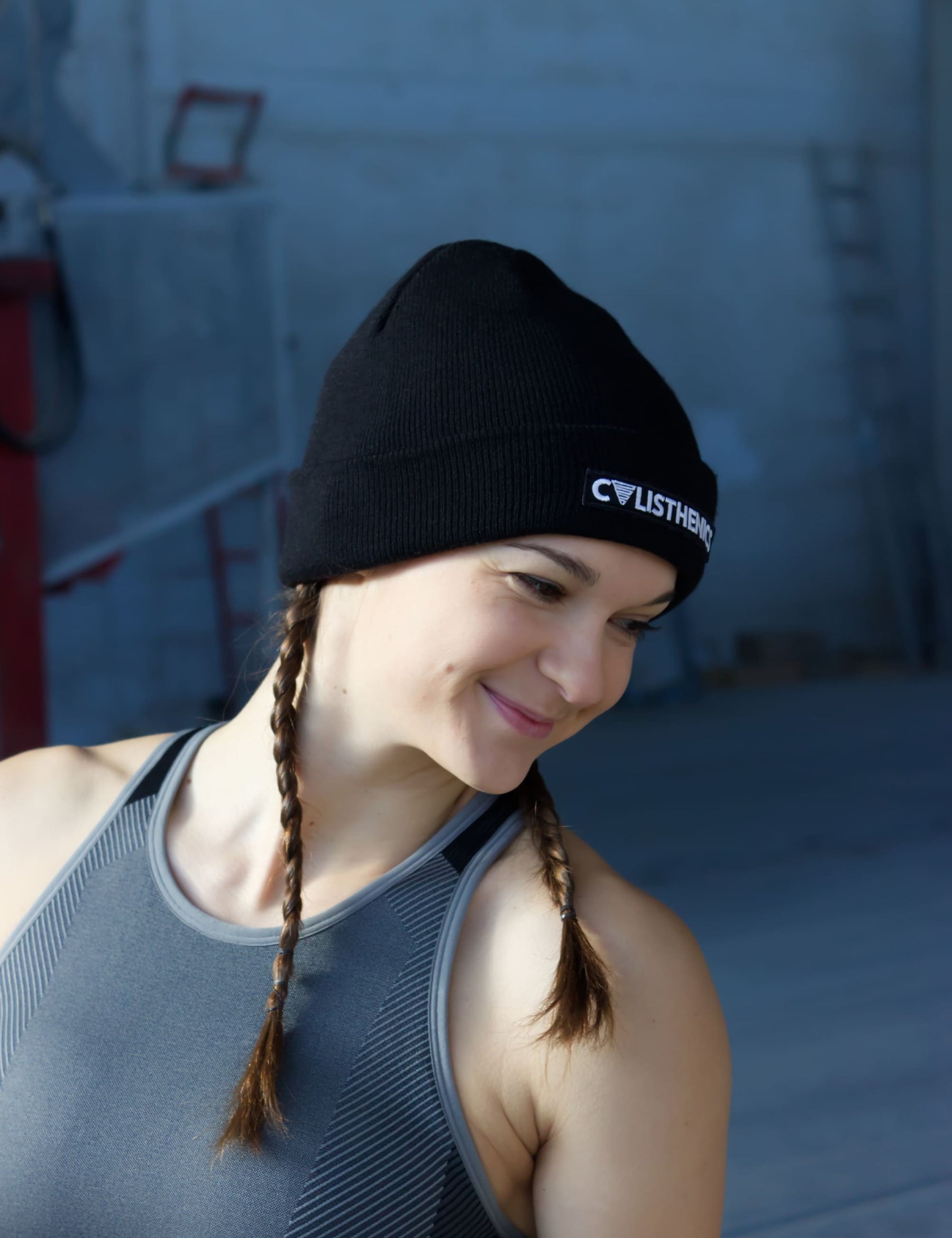 Calisthenics athlete Iris Easy wearing the black beanie with Calisthenics print and perfomance crop top by Gornation.
