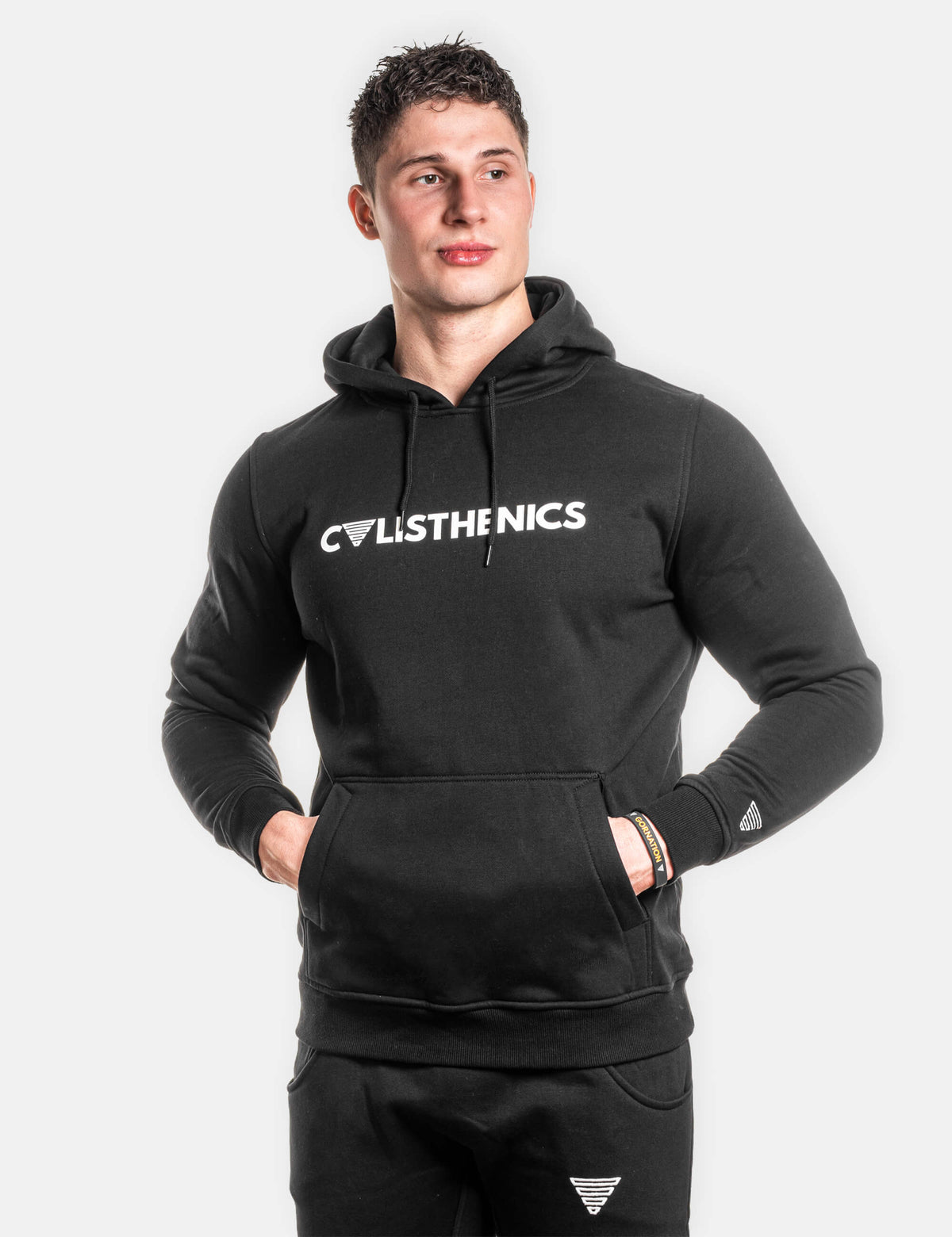 Front view of the Calisthenics hoodie from Gornation and skinny sweatpants presenting the Calisthenics text and Gornation logo.